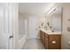 Bathroom with a double sink vanity, shower-tub combo, and tiled floors at 132 Ryder Cup Cir, Raleigh, NC 27603