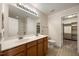 Bright bathroom featuring a double sink vanity and access to a walk-in closet at 132 Ryder Cup Cir, Raleigh, NC 27603