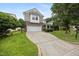 Well-manicured front yard of a home featuring a stone facade and an attached two-car garage at 132 Ryder Cup Cir, Raleigh, NC 27603