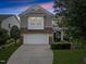 Charming two-story home with stone accents, manicured lawn, and an attached two-car garage at 132 Ryder Cup Cir, Raleigh, NC 27603