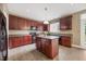 Well-lit kitchen with dark cabinets, stainless steel appliances, and tile flooring at 132 Ryder Cup Cir, Raleigh, NC 27603