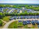 Aerial view of a well-planned community boasting neat rows of houses, lush greenery, and serene landscaping at 132 Yellow River Way, Garner, NC 27529