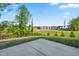 Backyard featuring a concrete patio area, grassy lawn, and a view of neighborhood homes at 132 Yellow River Way, Garner, NC 27529
