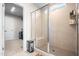 Shower features a frameless glass door, tiled walls, a built-in bench, and a clear view of the walk-in closet at 132 Yellow River Way, Garner, NC 27529