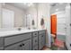 Bathroom featuring double vanity, a large mirror, and an adjacent toilet and shower area at 132 Yellow River Way, Garner, NC 27529