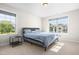 Sunlit bedroom featuring two windows, carpeted floors, and a contemporary platform bed at 132 Yellow River Way, Garner, NC 27529