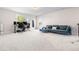 Spacious bonus room features ample natural light, plush carpeting, and a comfortable sectional sofa, perfect for relaxation at 132 Yellow River Way, Garner, NC 27529