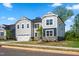 Charming two-story home showcases a two-car garage, gray siding, stone accents and well-maintained lawn at 132 Yellow River Way, Garner, NC 27529
