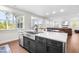 Modern kitchen island featuring stainless steel appliances, a sink, and open floor-plan living at 132 Yellow River Way, Garner, NC 27529