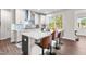 Modern kitchen features a large island with seating, stainless steel appliances, and bright natural light at 132 Yellow River Way, Garner, NC 27529