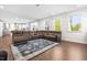 Spacious living room features hardwood floors, ample windows, and an area rug, providing an open and airy feel at 132 Yellow River Way, Garner, NC 27529