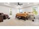 Bright main bedroom offers a tray ceiling, ample sunlight, walk-in closet, and en-suite bathroom at 132 Yellow River Way, Garner, NC 27529