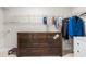 Spacious walk-in closet with wood dresser and custom shelving providing ample storage for clothes and accessories at 132 Yellow River Way, Garner, NC 27529