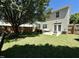 Large, well-maintained backyard with a concrete patio, outdoor furniture, and a grill at 137 Palmdale Ct, Holly Springs, NC 27540