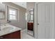 This bathroom features a cherry wood vanity with white countertops and a decorative window for natural light at 137 Palmdale Ct, Holly Springs, NC 27540