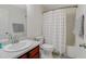 Well-lit bathroom with white fixtures, including a sink, toilet, and tub/shower at 137 Palmdale Ct, Holly Springs, NC 27540