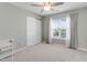 Bright, neutral bedroom with a ceiling fan and large window that provides natural light at 137 Palmdale Ct, Holly Springs, NC 27540