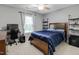 This bedroom offers a ceiling fan and a large window for lots of natural light at 137 Palmdale Ct, Holly Springs, NC 27540
