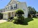 Exterior view of a well-maintained home with green lawn and mature landscaping in a suburban neighborhood at 137 Palmdale Ct, Holly Springs, NC 27540