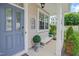 Inviting front porch with a bench and decorative plants, leading to a stylish front door at 137 Palmdale Ct, Holly Springs, NC 27540