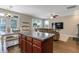 Modern kitchen showcasing island with seating, open to the living and dining areas at 137 Palmdale Ct, Holly Springs, NC 27540