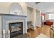 Elegant fireplace with decorative mirror and cozy chair near the kitchen at 137 Palmdale Ct, Holly Springs, NC 27540