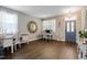 Elegant living room with decorative mirrors, wood flooring, and a charming entryway at 137 Palmdale Ct, Holly Springs, NC 27540