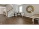 Inviting living space featuring stylish decor, wood floors, and a staircase at 137 Palmdale Ct, Holly Springs, NC 27540