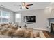 Bright living room featuring modern TV, fireplace, and comfortable seating area at 137 Palmdale Ct, Holly Springs, NC 27540
