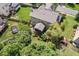 Aerial view of the home showcasing its solar panels, backyard, screened porch, fire pit, and fenced yard at 1504 Hemlock Hill Dr, Durham, NC 27703