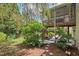 Inviting backyard features a lush garden, stone pathway, and a screened porch with outdoor seating area at 1504 Hemlock Hill Dr, Durham, NC 27703