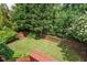 Fenced in backyard featuring a well manicured lawn and natural wooded area at 1504 Hemlock Hill Dr, Durham, NC 27703