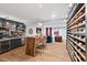 Stylish bar area in a finished basement with a live edge bar, seating, full bar, and wine storage at 1504 Hemlock Hill Dr, Durham, NC 27703