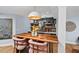 The basement bar features a live-edge bar top and comfortable seating under a modern dome light fixture at 1504 Hemlock Hill Dr, Durham, NC 27703
