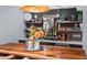 The Basement bar features marble counters, open shelving and custom cabinetry for an elevated entertaining experience at 1504 Hemlock Hill Dr, Durham, NC 27703