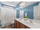 Bright bathroom with double sinks, a shower with a tub and a neutral shower curtain at 1504 Hemlock Hill Dr, Durham, NC 27703