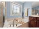 Luxurious bathroom featuring a soaking tub with jets and a decorative window for natural light at 1504 Hemlock Hill Dr, Durham, NC 27703