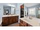 Elegant bathroom featuring double sinks, wooden cabinets, and a large mirror at 1504 Hemlock Hill Dr, Durham, NC 27703