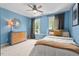 Blue bedroom with two windows and neutral color scheme, featuring natural light and comfortable furnishings at 1504 Hemlock Hill Dr, Durham, NC 27703