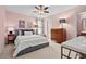Cozy bedroom with pink walls, a ceiling fan, and well-placed lighting for a warm ambiance at 1504 Hemlock Hill Dr, Durham, NC 27703