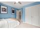 Bright bedroom with a large closet and sports decor, featuring a queen bed with white linens at 1504 Hemlock Hill Dr, Durham, NC 27703