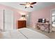 Bright pink bedroom featuring a dresser, bedside table, and a comfortable bed at 1504 Hemlock Hill Dr, Durham, NC 27703