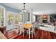 Breakfast nook with wood floors, backyard access, and open view of the living room fireplace at 1504 Hemlock Hill Dr, Durham, NC 27703