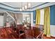 Open-concept dining room connecting to the foyer and featuring hardwood floors, a stylish light fixture, and inviting decor at 1504 Hemlock Hill Dr, Durham, NC 27703