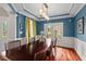 Bright dining room with hardwood floors, modern lighting, and French doors overlooking the outdoor patio and garden at 1504 Hemlock Hill Dr, Durham, NC 27703