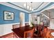Elegant dining space blending wood floors and decor, leading to a staircase and showcasing blue accent walls at 1504 Hemlock Hill Dr, Durham, NC 27703