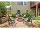 Backyard brick fire pit with chairs, creating a cozy outdoor gathering spot at 1504 Hemlock Hill Dr, Durham, NC 27703
