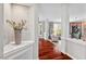 Hallway featuring hardwood flooring and a view into living room, enhancing the home's flow and open feel at 1504 Hemlock Hill Dr, Durham, NC 27703