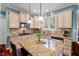 Kitchen featuring granite countertops, stainless steel appliances, and an island with bar seating at 1504 Hemlock Hill Dr, Durham, NC 27703