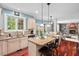 Bright kitchen boasts granite counters, stainless appliances, island with seating, and an open design to living areas at 1504 Hemlock Hill Dr, Durham, NC 27703
